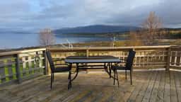 The shared terrace with tables and chairs, facing Tromsø